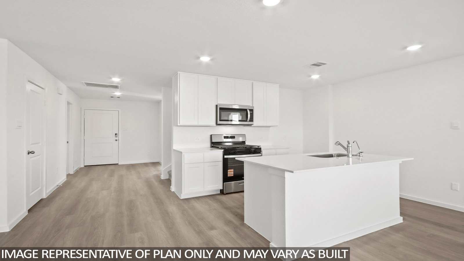 Kitchen with quartz countertops and an island and vinyl floor
