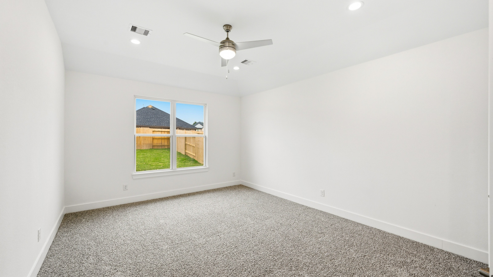 Secondary bedroom with shag carpet flooring and bright window