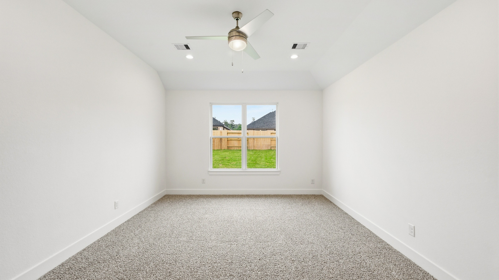 Large Primary bedroom with shag carpet flooring and bright window