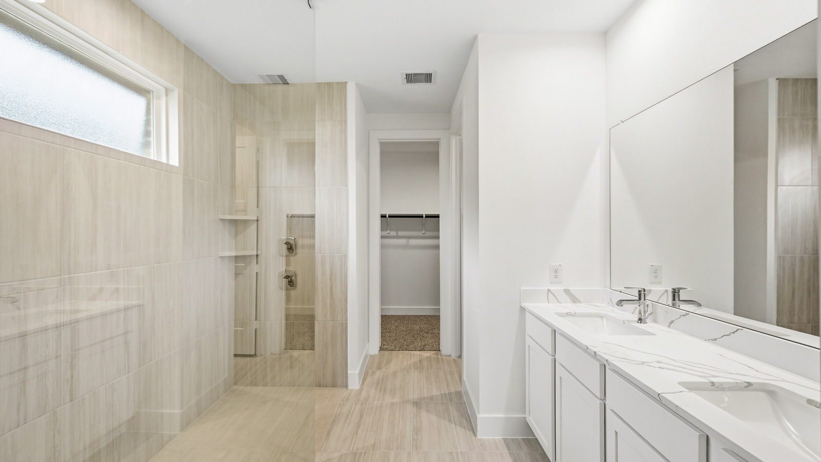Primary bathroom with stand-alone shower with tiles and semi frameless glass in Magnolia TX