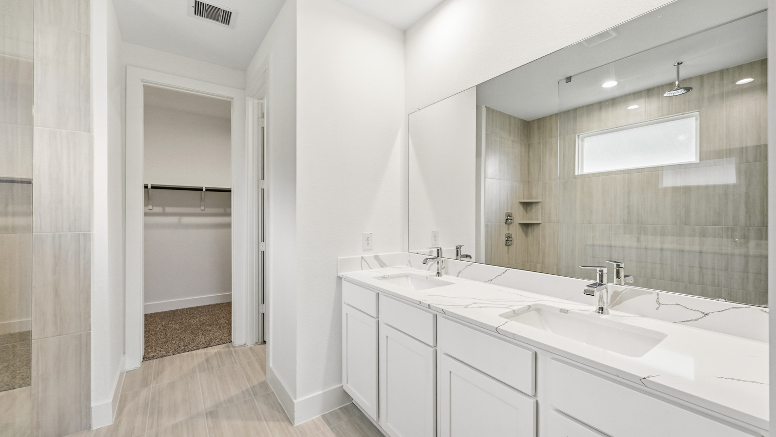 Primary bathroom with stand-alone shower with tiles and semi frameless glass in Magnolia TX