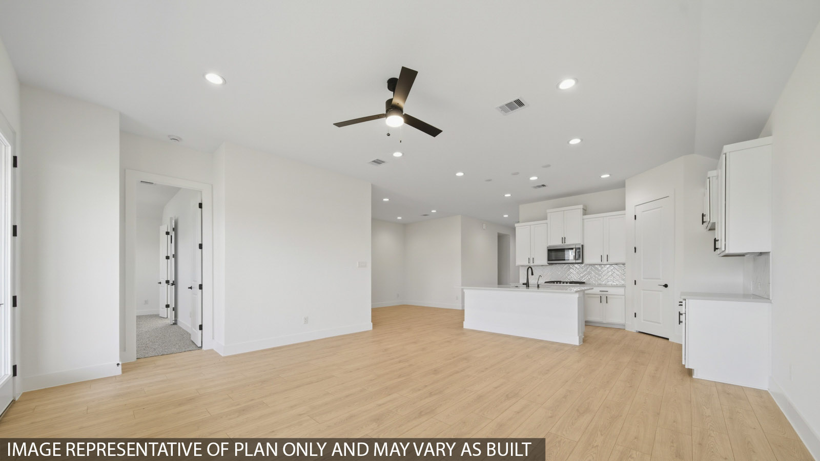 Kitchen with quartz countertops and marden hardware and an island and vinyl floor