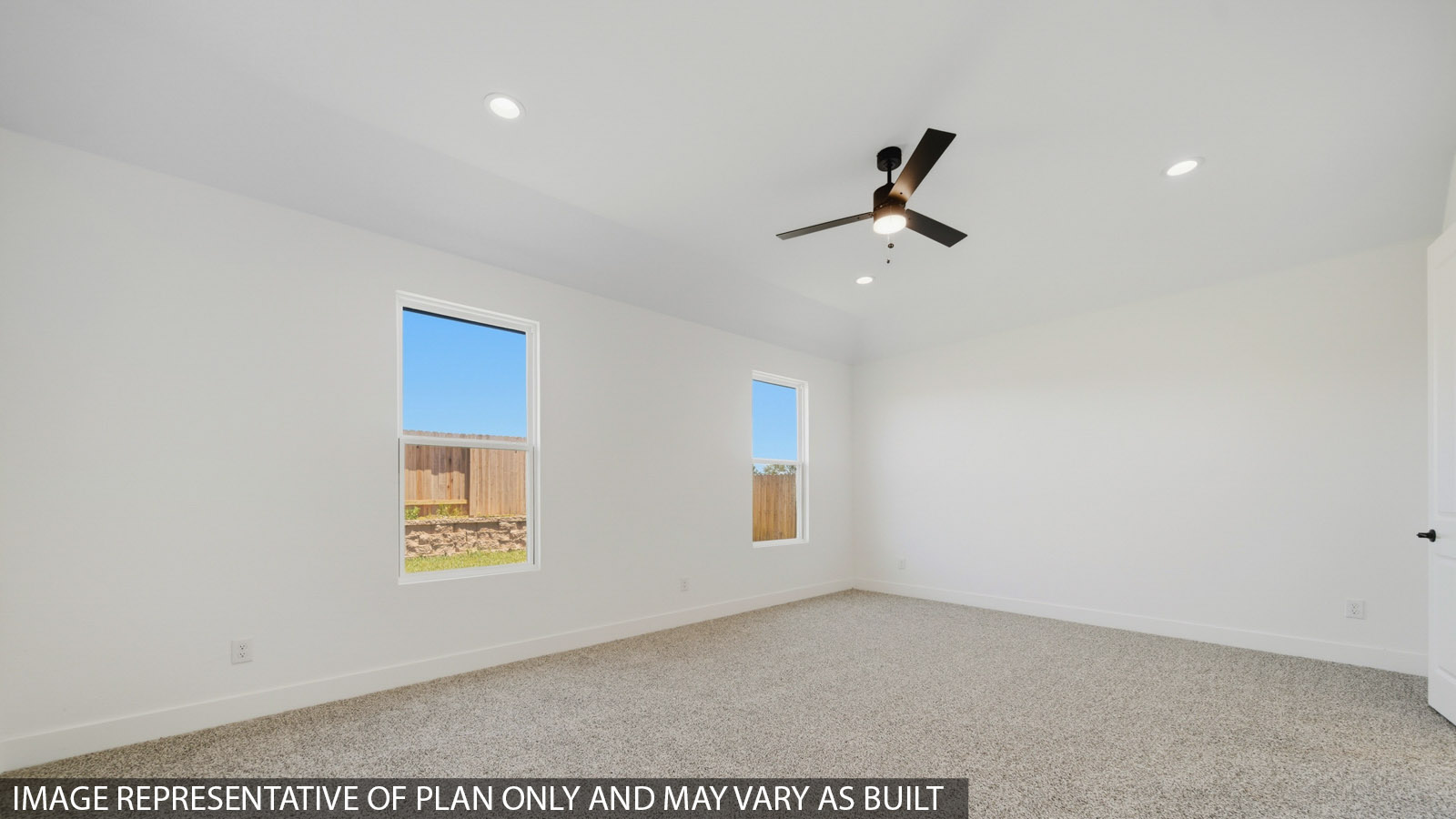 Large Primary bedroom with shag carpet flooring and bright window