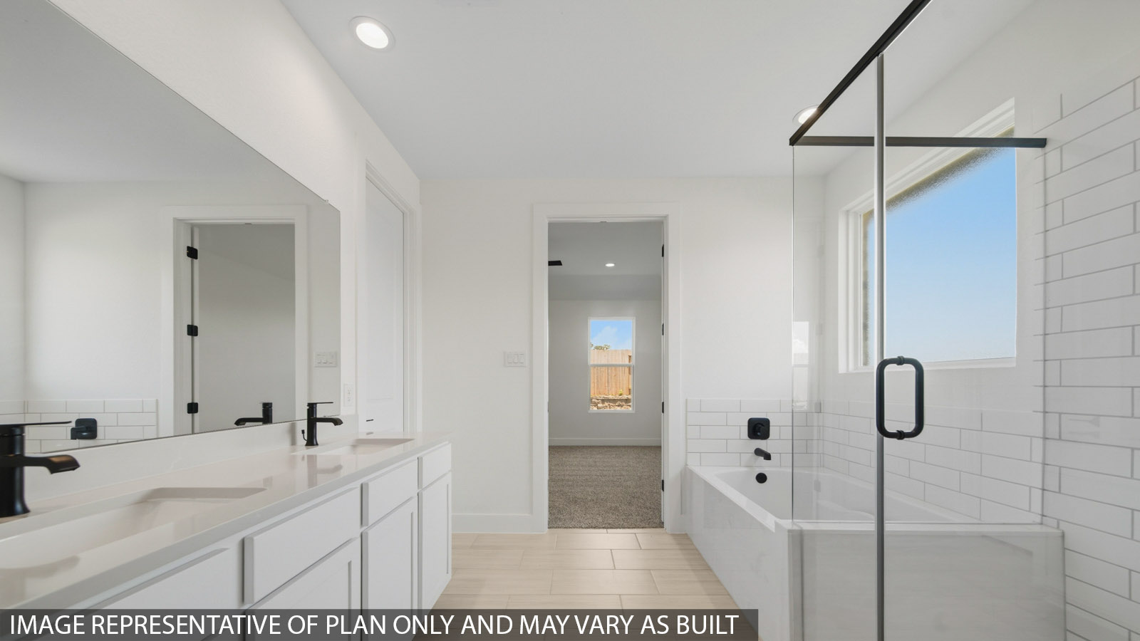 Primary bathroom with soaker tub and tile shower with semi frameless glass in Magnolia TX