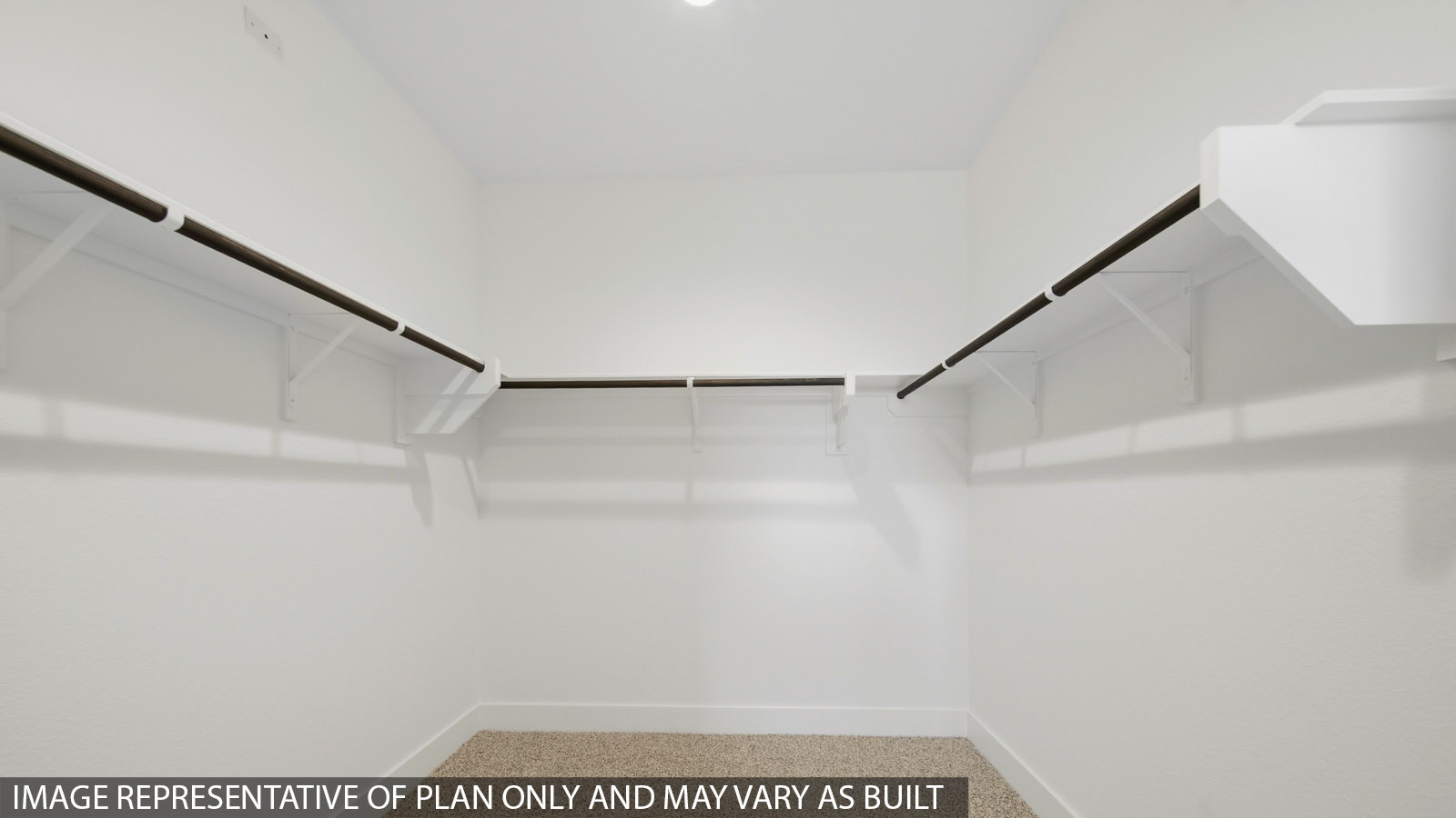 Primary bedroom walk-in closet with carpet flooring in Mill Creek community in Magnolia TX