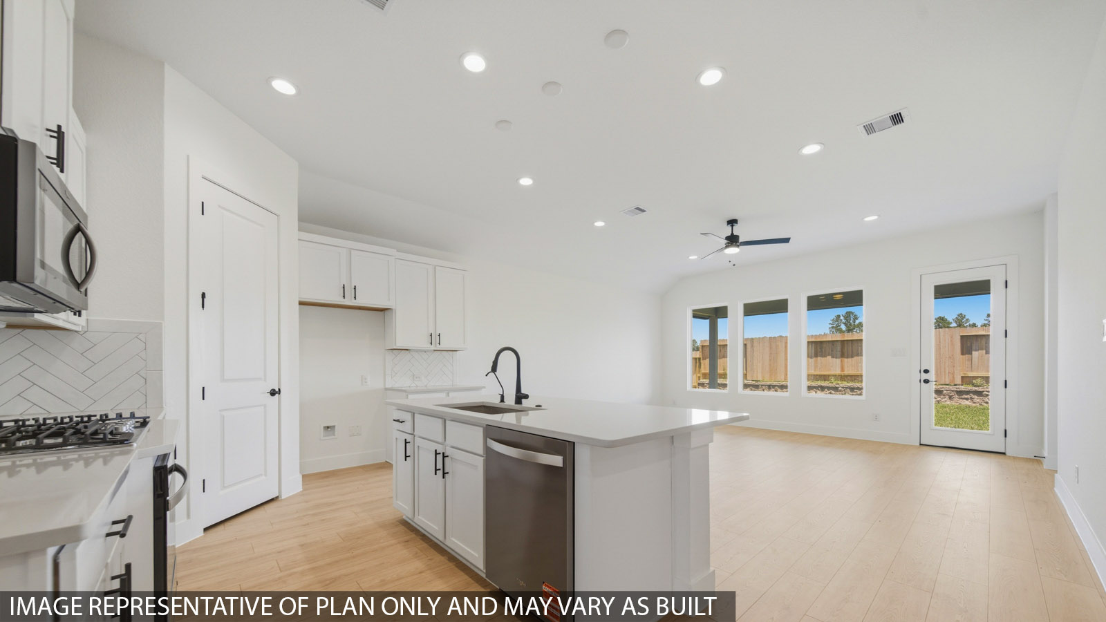 Kitchen with quartz countertops and marden hardware and an island and vinyl floor