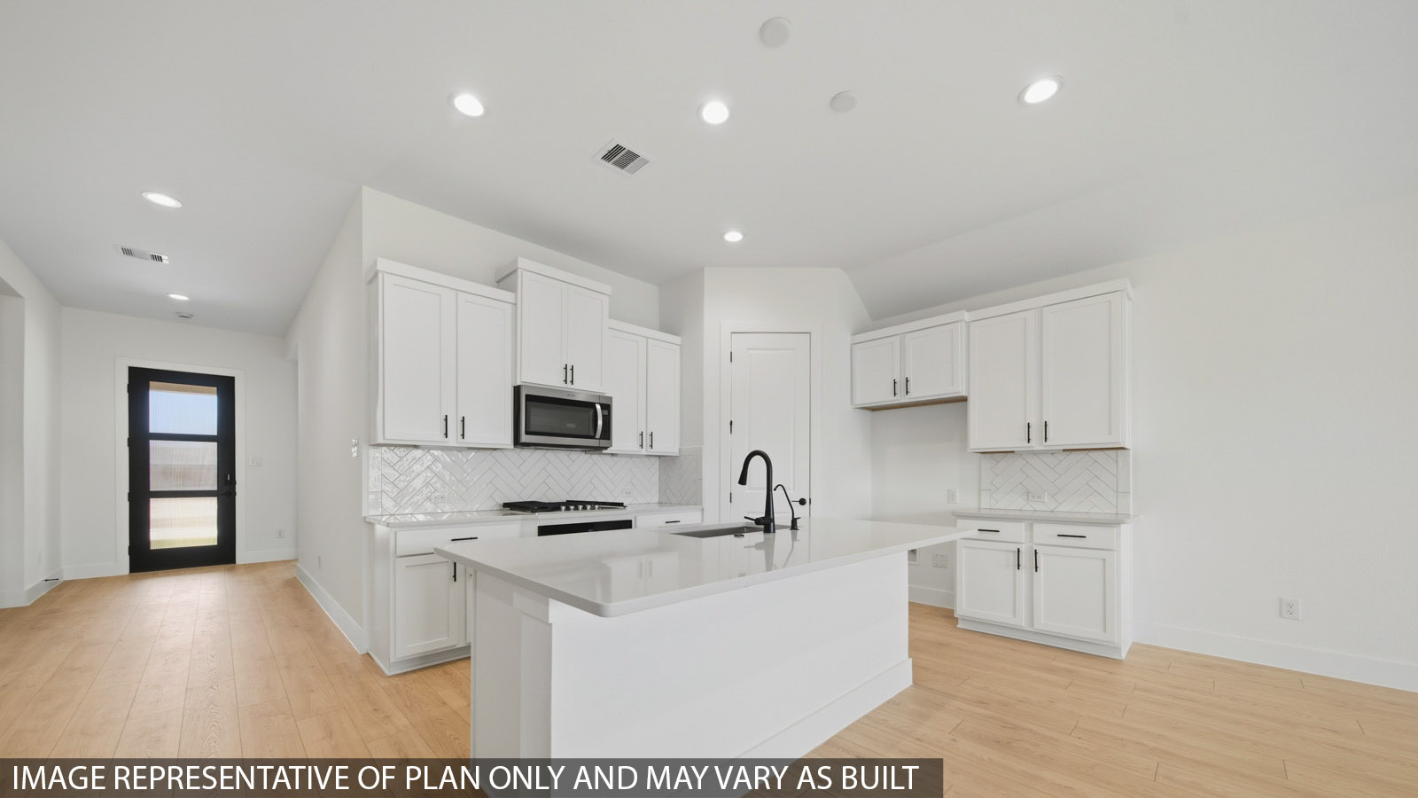 Kitchen with quartz countertops and marden hardware and an island and vinyl floor