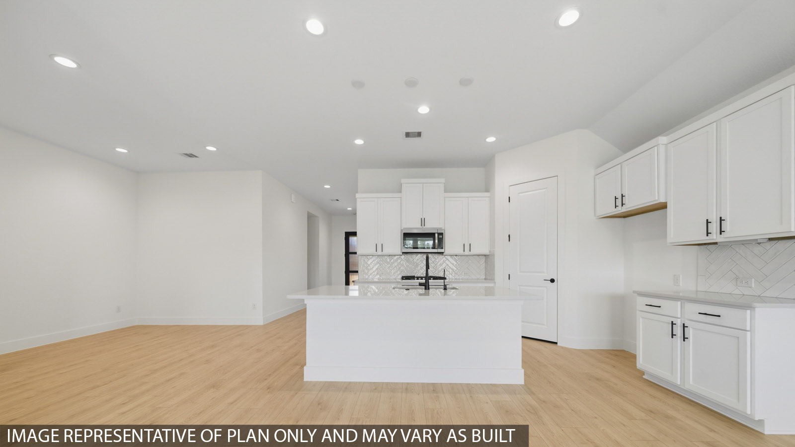 Kitchen with quartz countertops and marden hardware and an island and vinyl floor