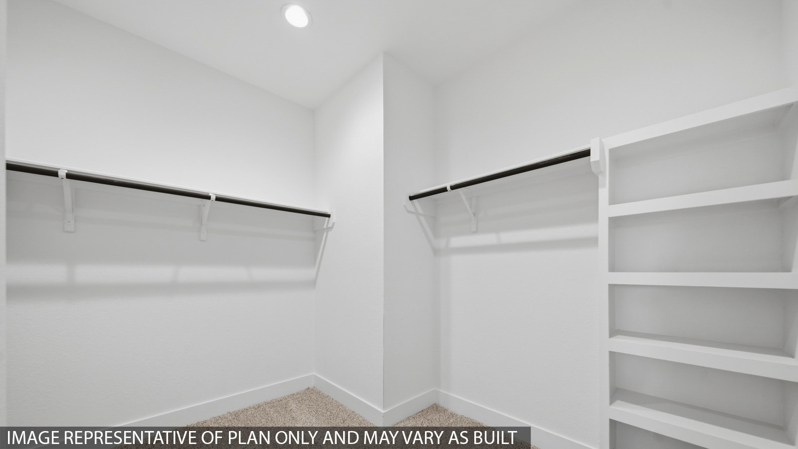 Primary bedroom walk-in closet with carpet flooring in Mill Creek community in Magnolia TX