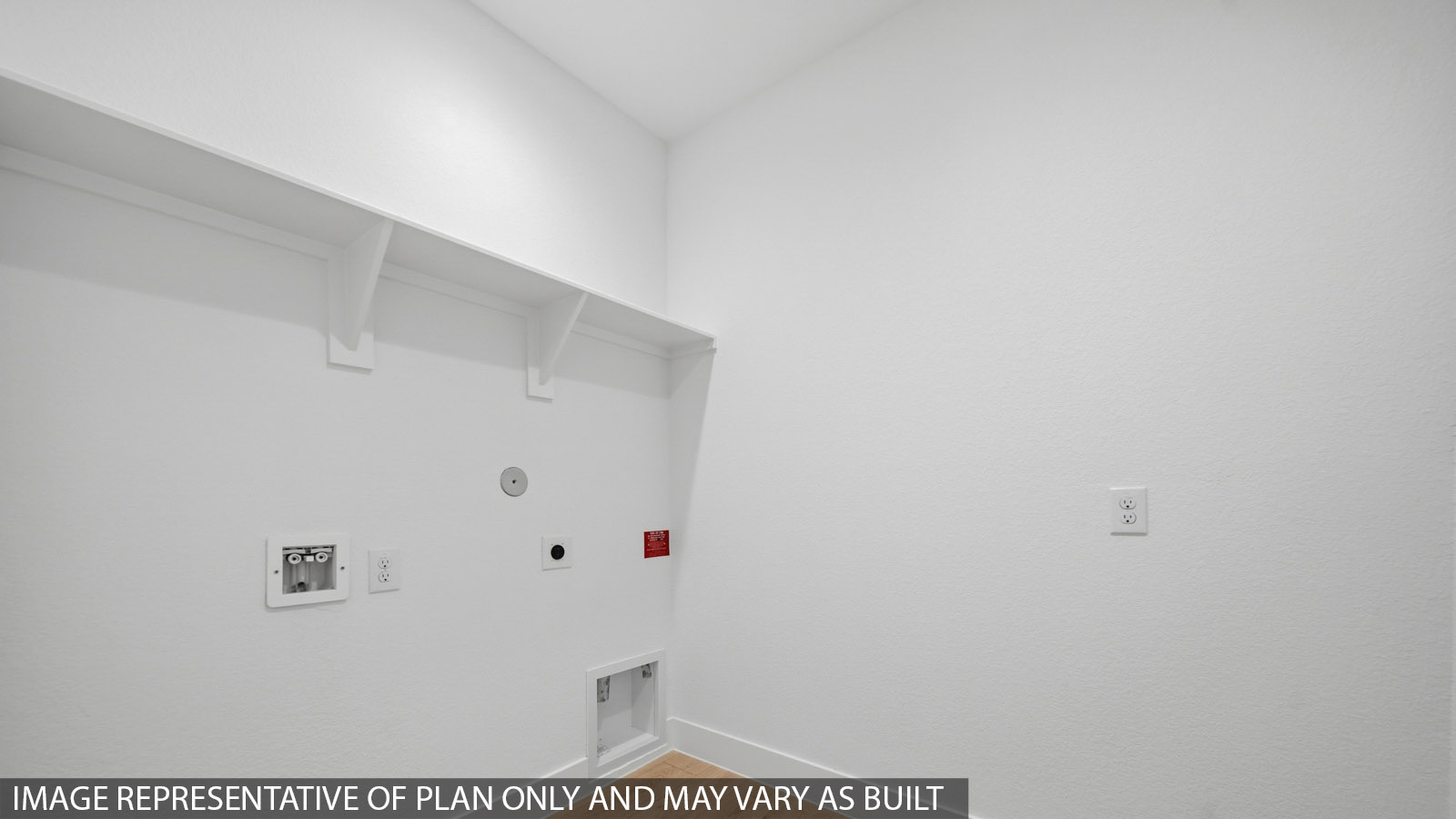 Utility room with storage located off the entry hallway and garage door