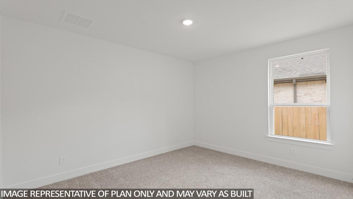 Secondary bedroom with shag carpet flooring and bright window