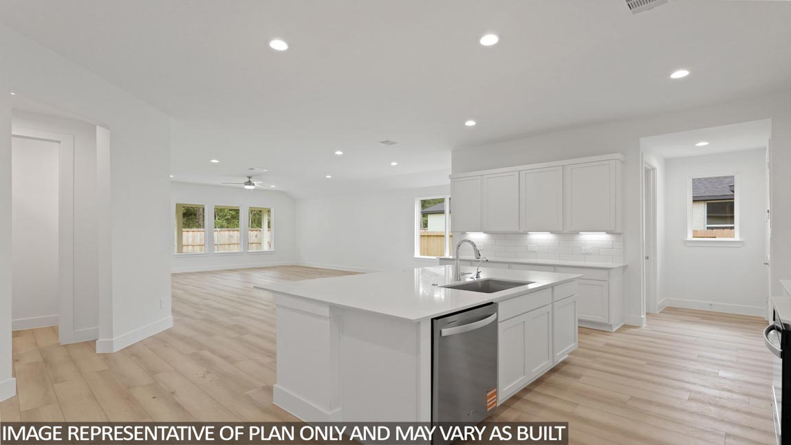 Kitchen with quartz countertops and marden hardware and an island and vinyl floor