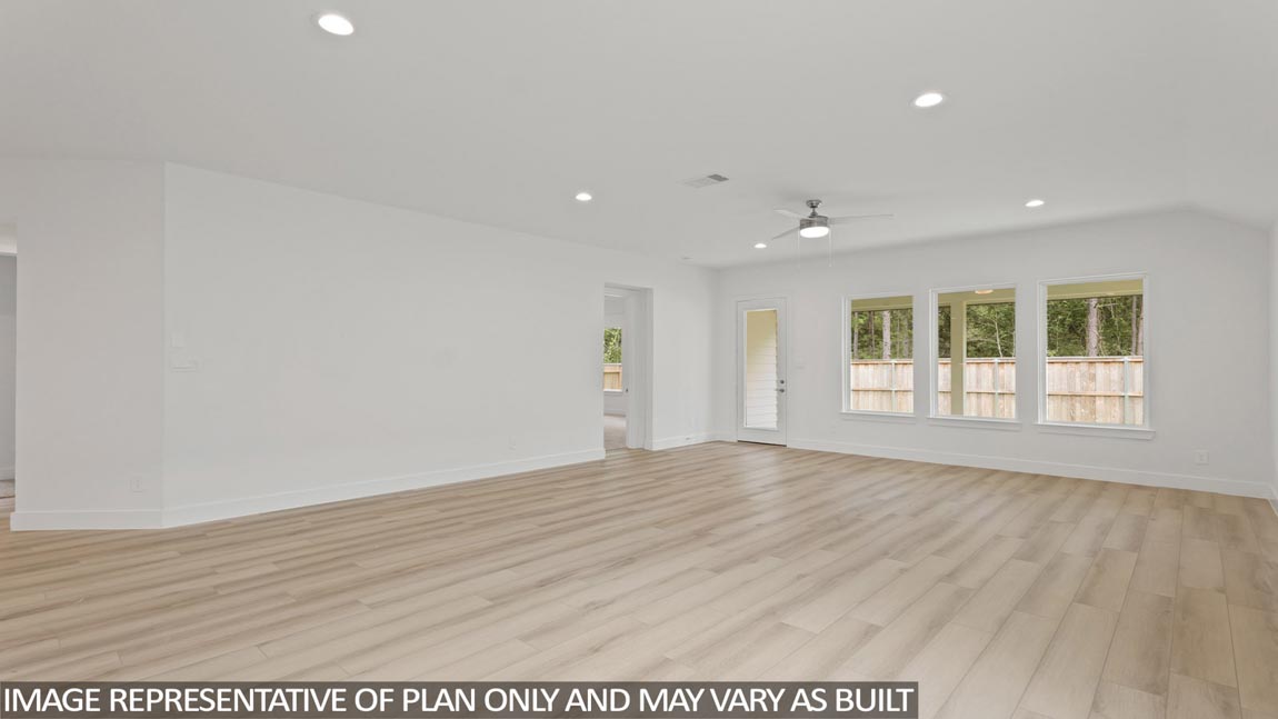 Spacious living area with vinyl flooring and bright windows in Magnolia TX