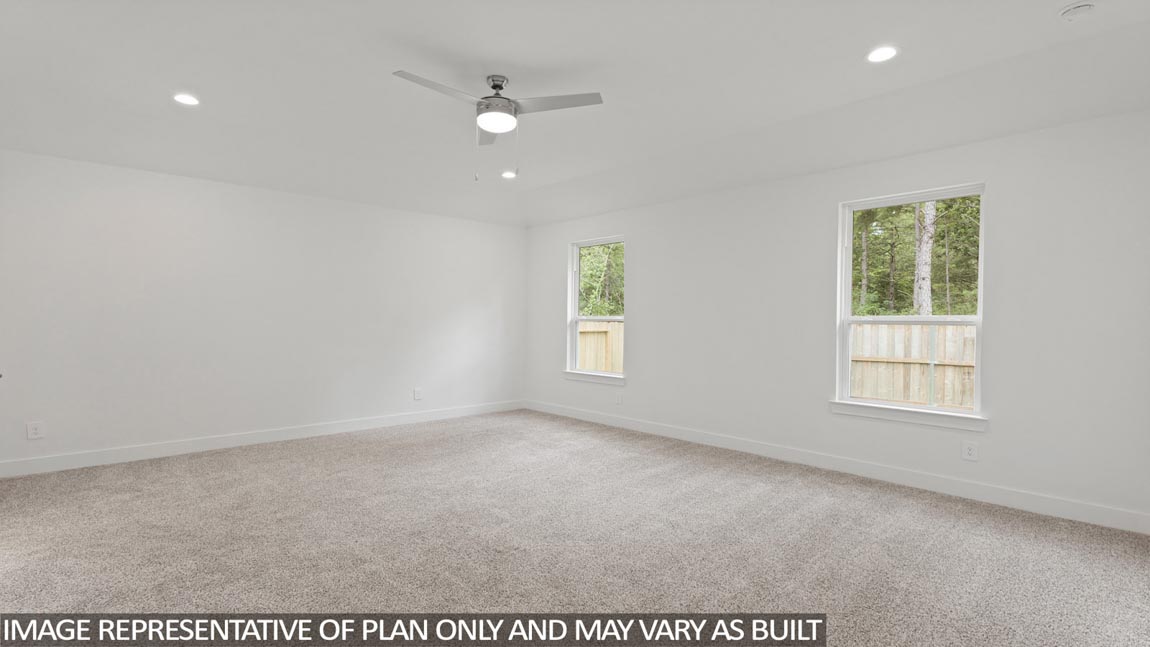 Large Primary bedroom with shag carpet flooring and bright window