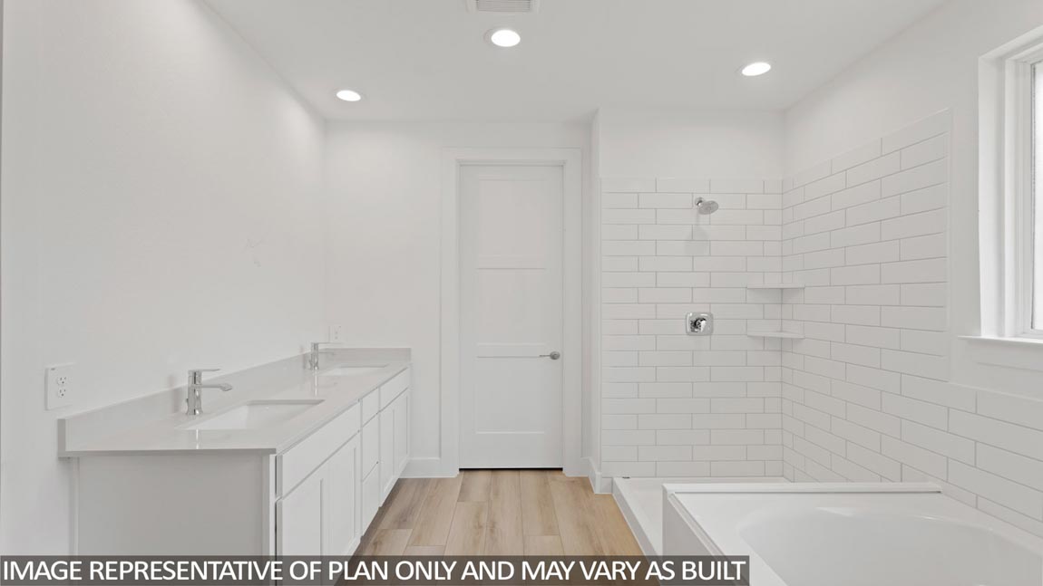 Primary bathroom with soaker tub and tile shower with semi frameless glass in Magnolia TX