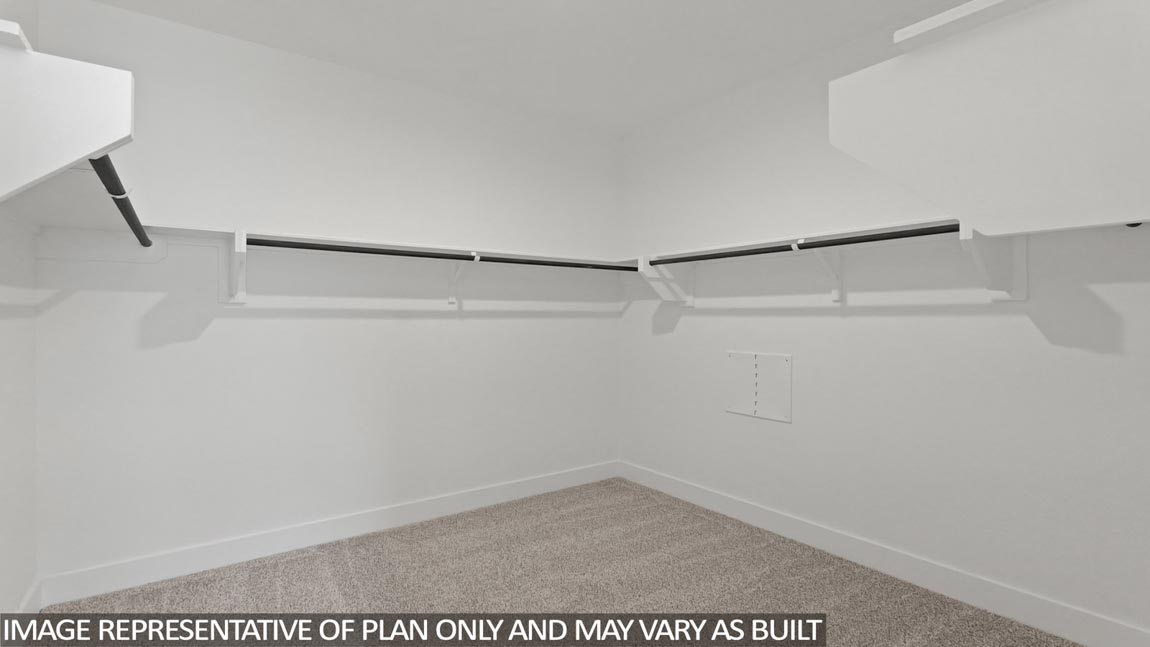 Primary bedroom walk-in closet with carpet flooring in Mill Creek community in Magnolia TX