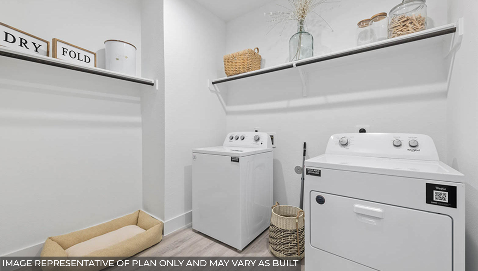 Utility room with storage located off the entry hallway and garage door