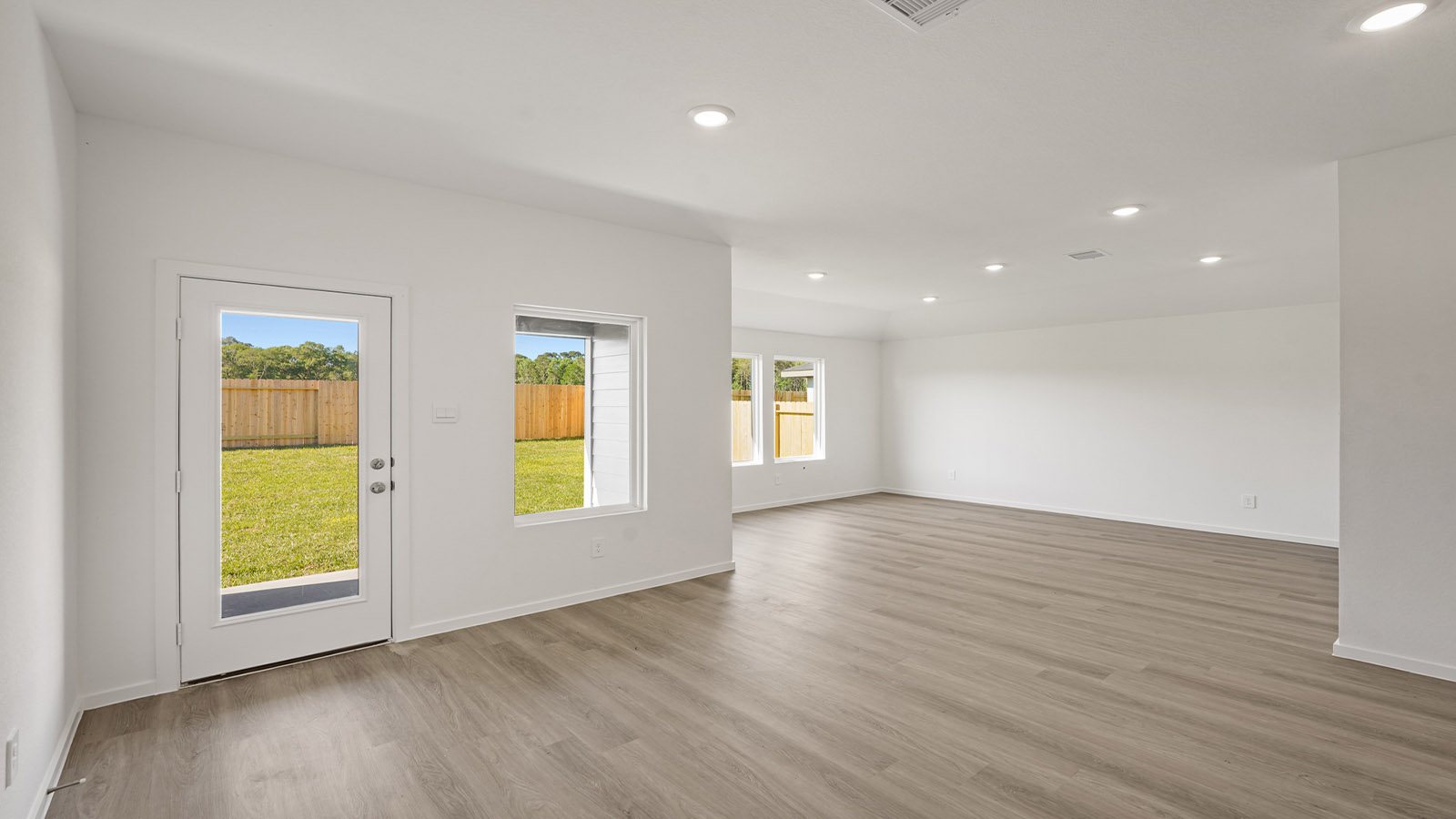 Spacious living area with vinyl flooring