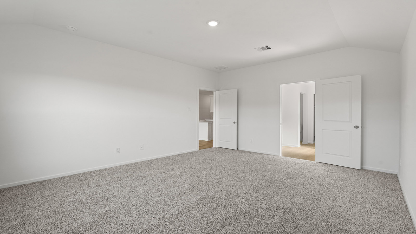 Primary bedroom with carpet flooring