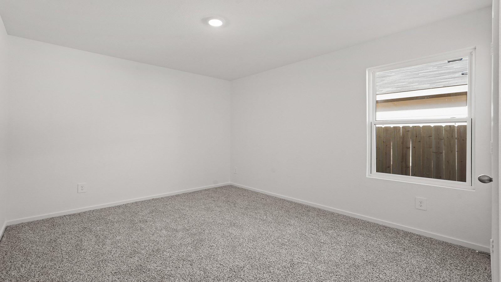 Secondary bedroom with carpet flooring