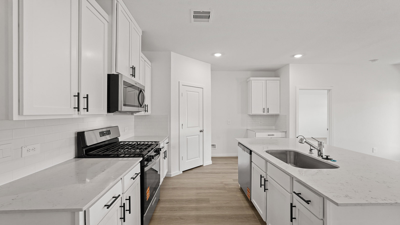 Kitchen with an island and vinyl floor