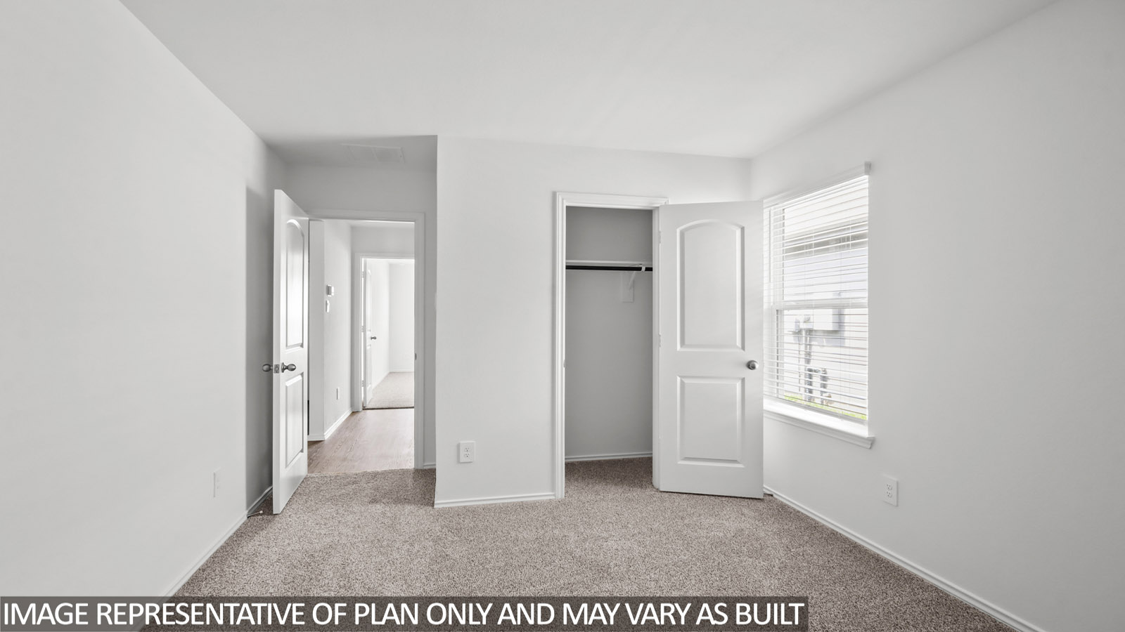 Secondary bedroom with carpet flooring