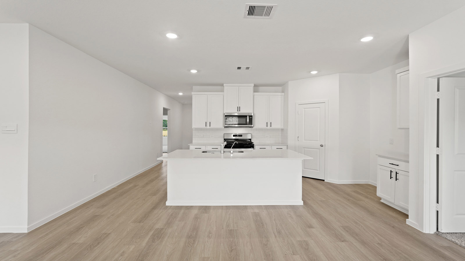 Kitchen with an island and vinyl floor