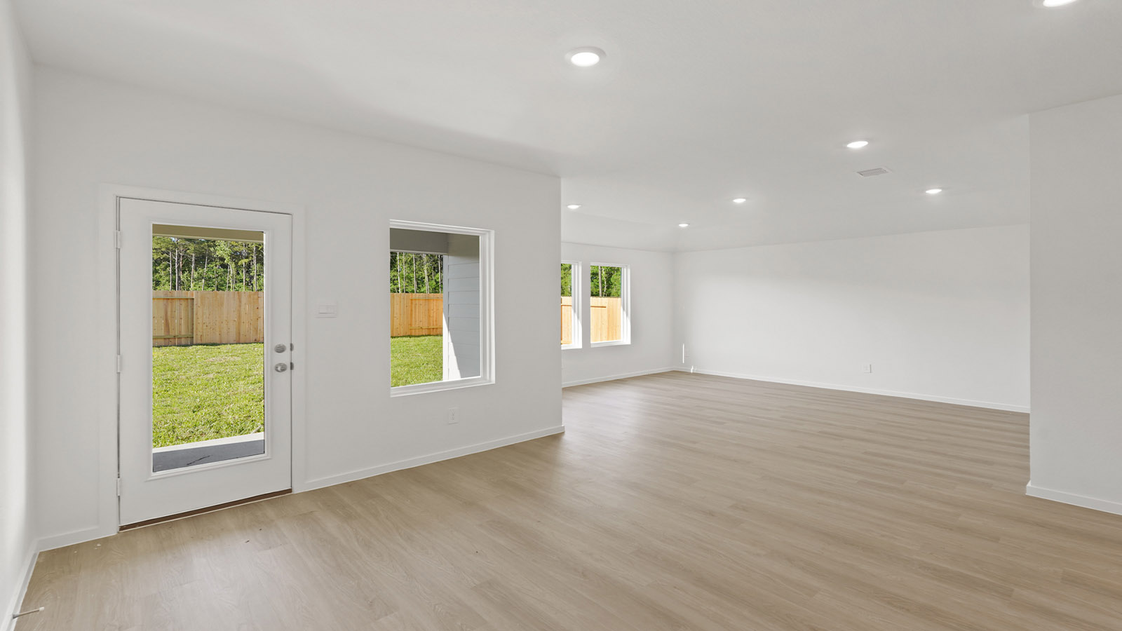 Spacious living area with vinyl flooring