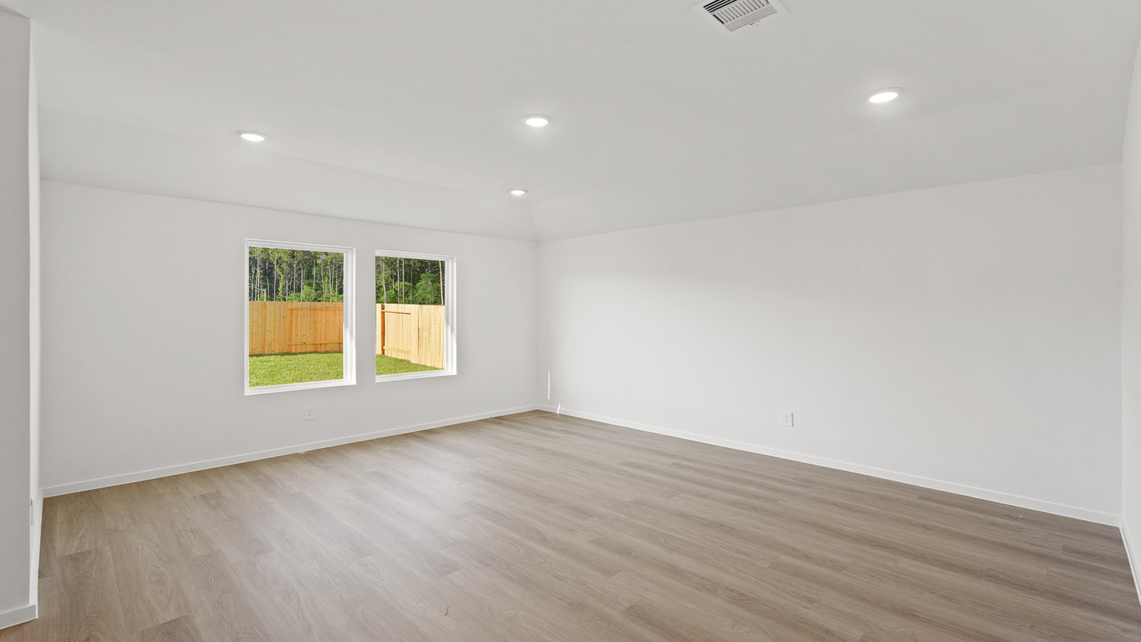 Spacious living area with vinyl flooring