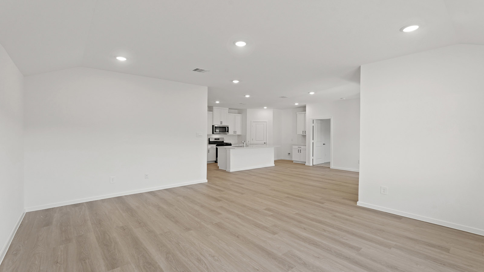 Spacious living area with vinyl flooring