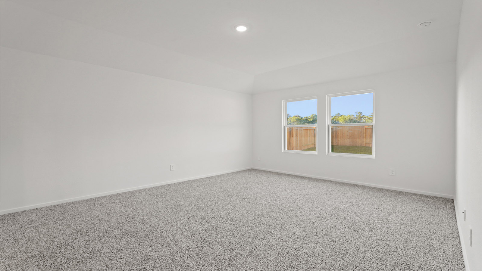 Primary bedroom with carpet flooring