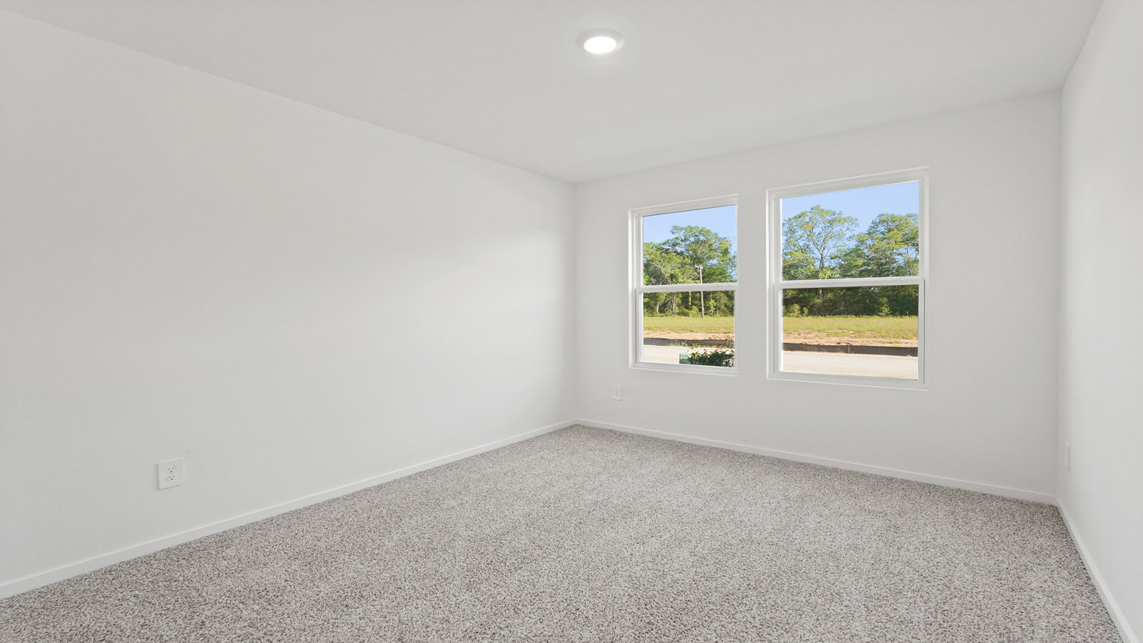 Secondary bedroom with carpet flooring