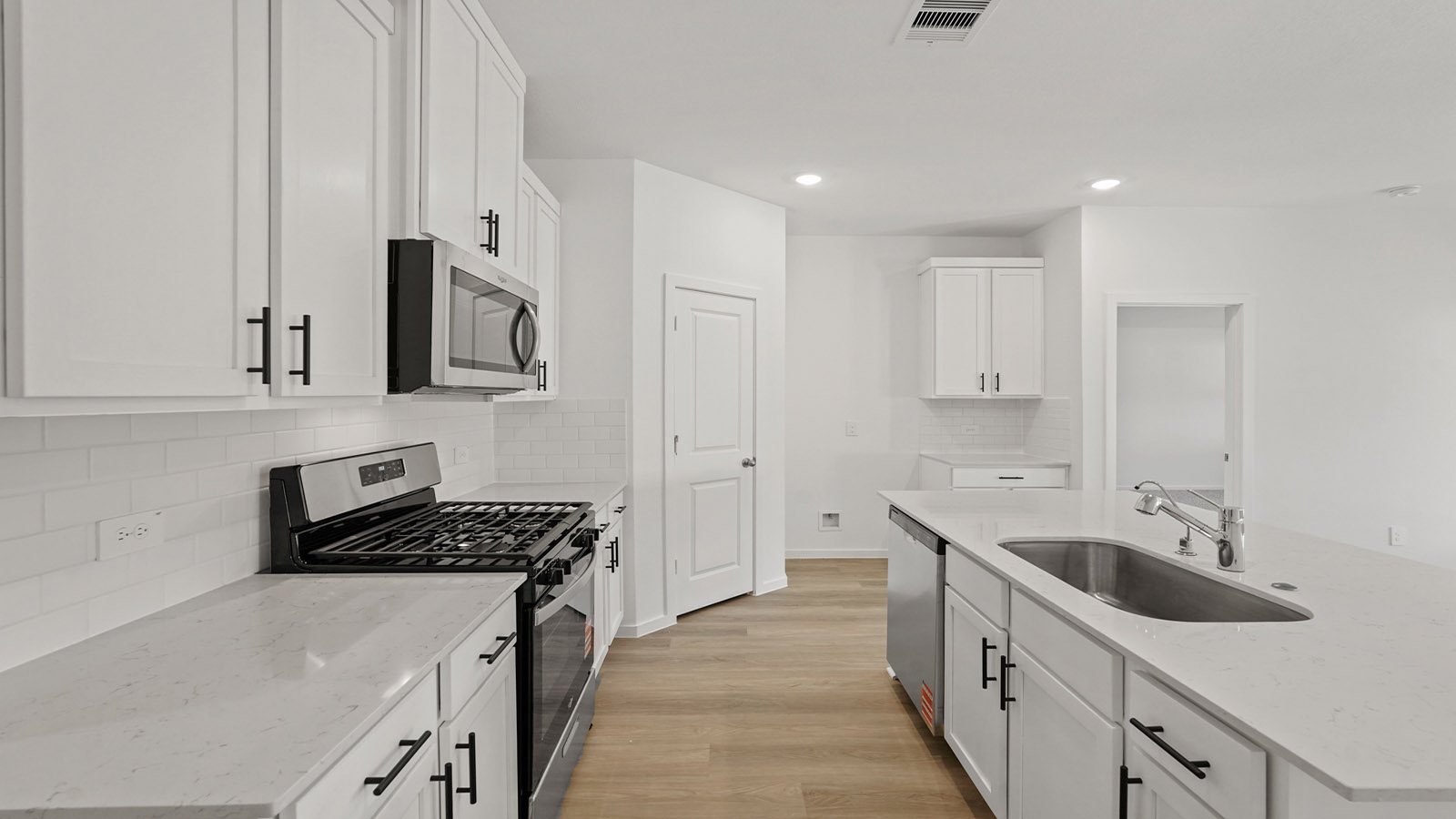Kitchen with an island and vinyl floor