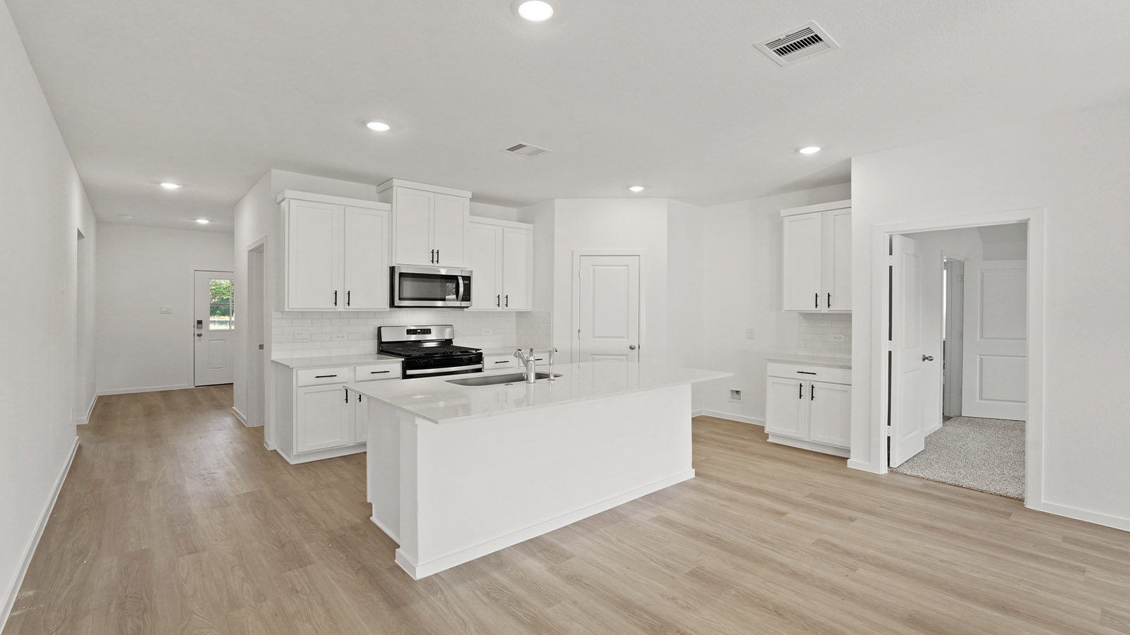 Kitchen with an island and vinyl floor