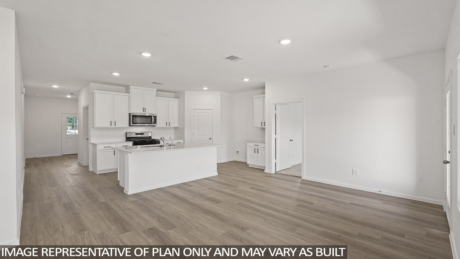 Kitchen with stainless steel appliances, quartz countertops and modern hardware and an island and vinyl floor