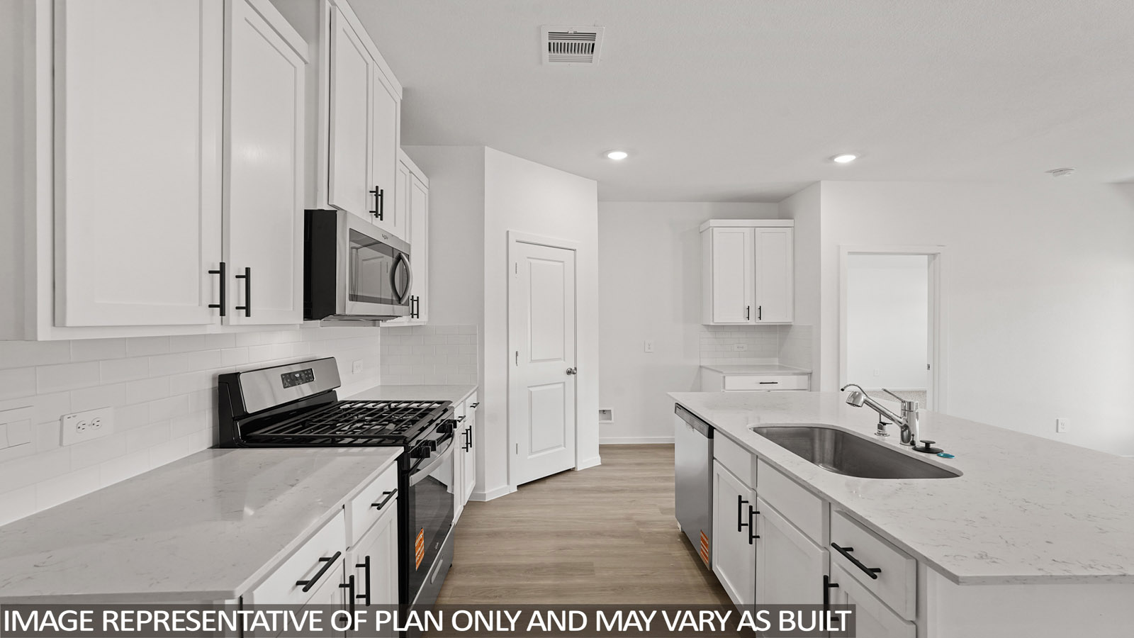 Kitchen with stainless steel appliances, quartz countertops and modern hardware and an island and vinyl floor