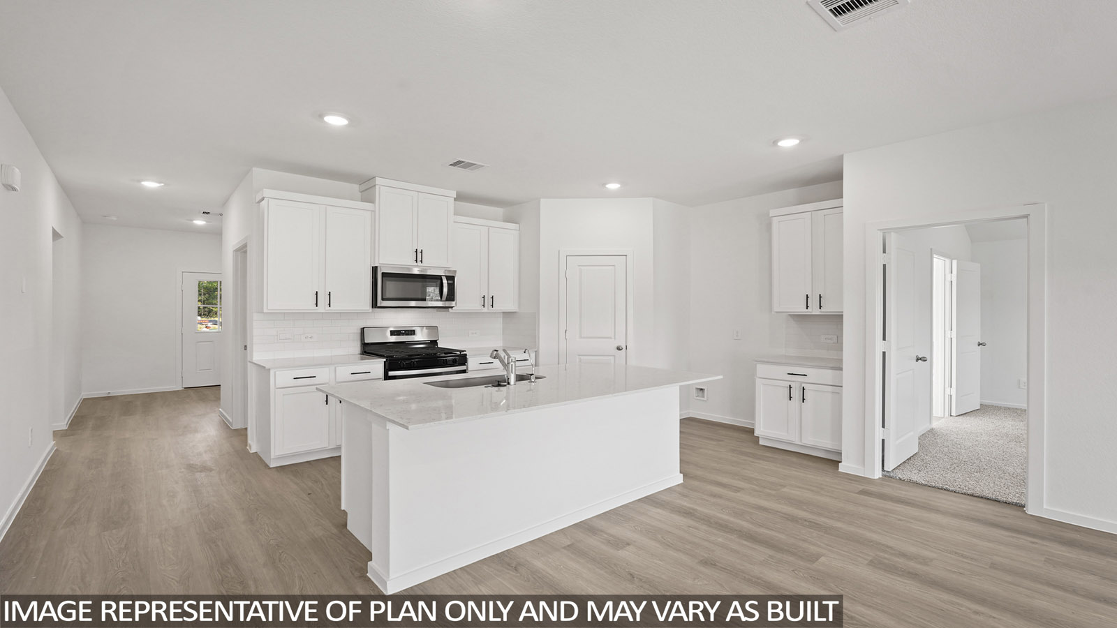 Kitchen with stainless steel appliances, quartz countertops and modern hardware and an island and vinyl floor