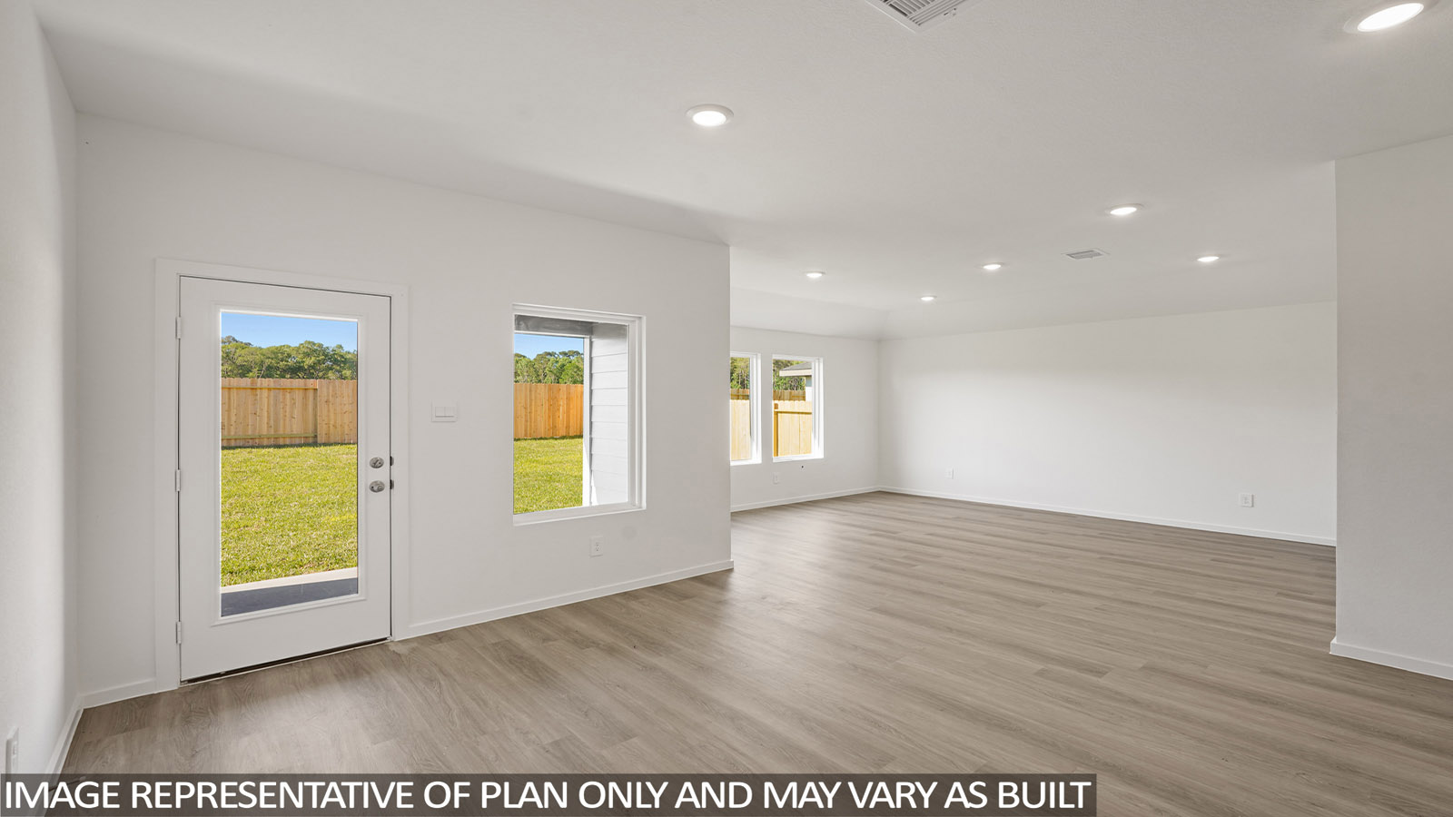 Spacious living area with vinyl flooring and bright windows in New Waverly TX