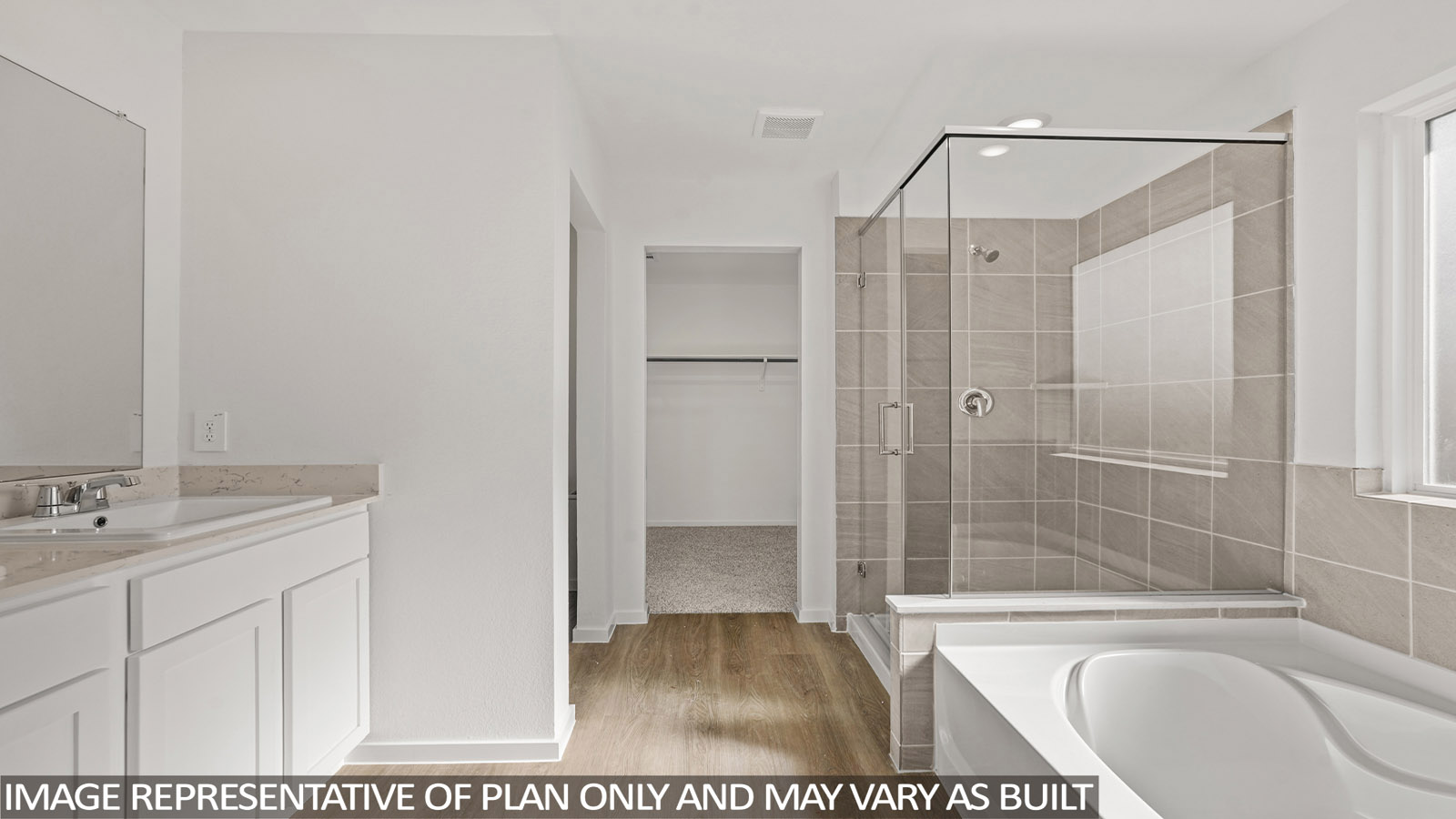 Primary bathroom with soaker tub and tile shower with semi frameless glass in New Waverly TX