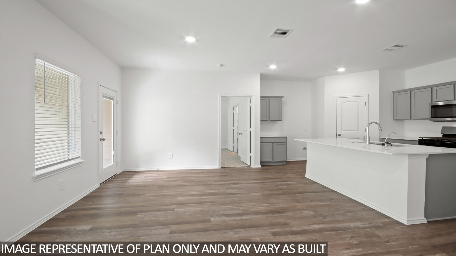 Spacious living area with vinyl flooring