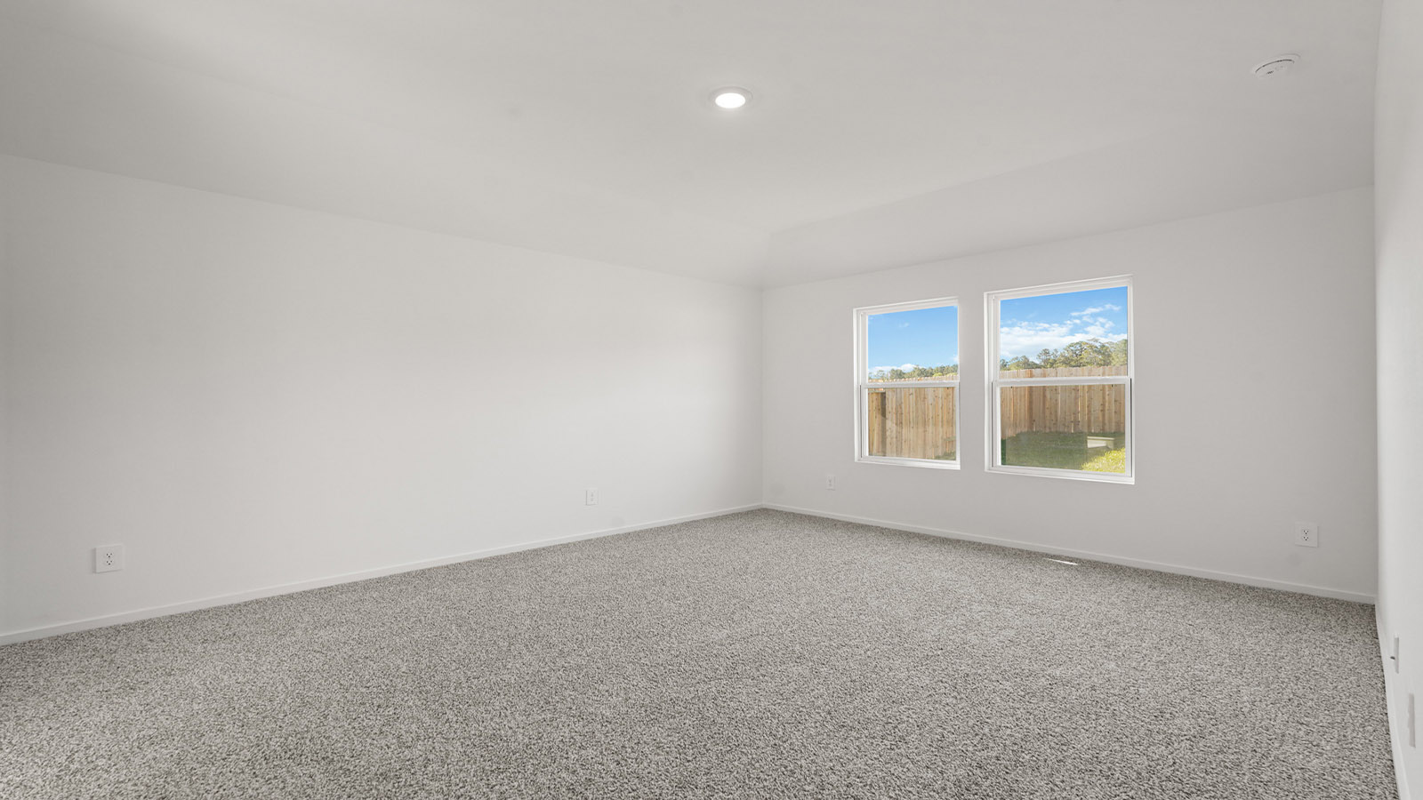 Primary bedroom with carpet flooring
