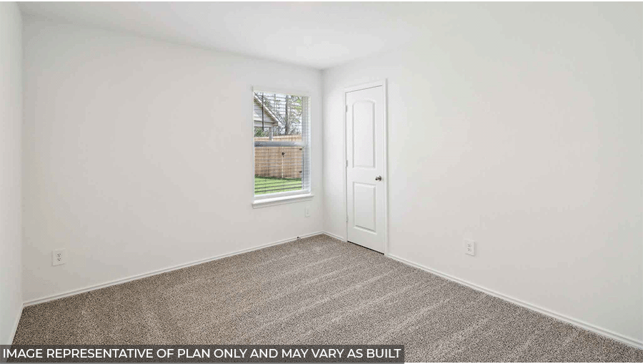 Secondary bedroom with carpet flooring
