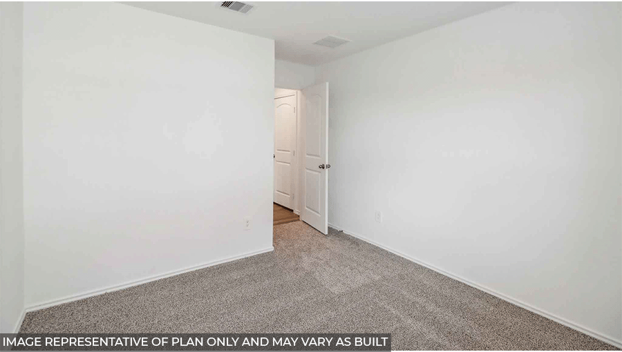 Secondary bedroom with carpet flooring