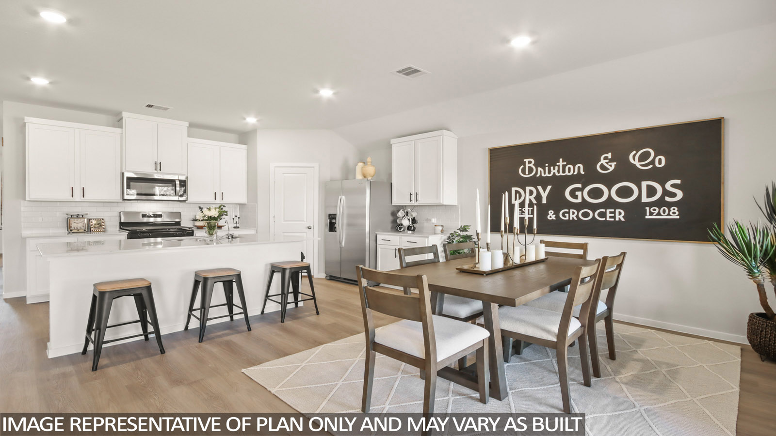 Kitchen with stainless steel appliances, quartz countertops and modern hardware and an island and vinyl floor