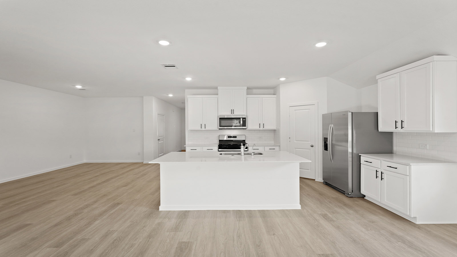 Kitchen with an island and vinyl floor