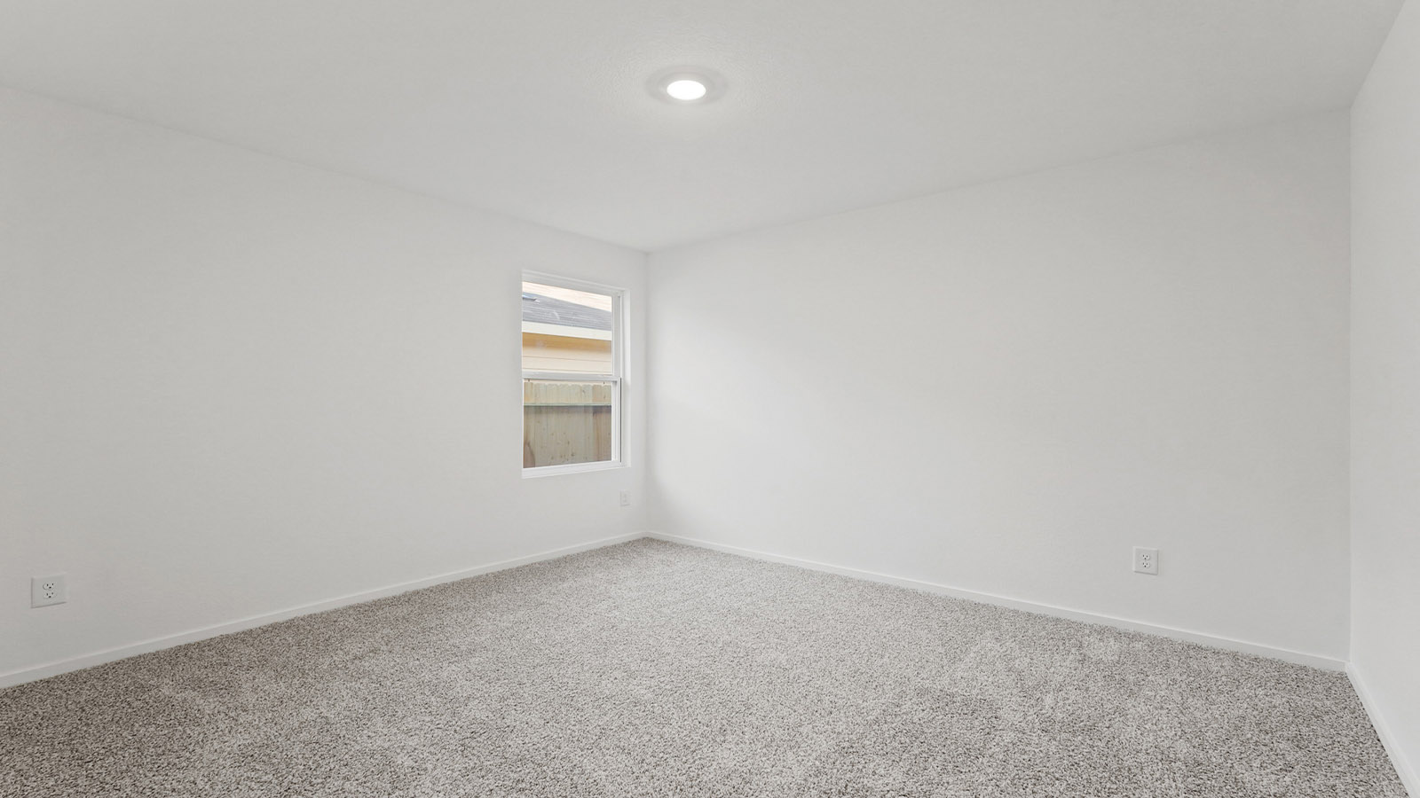 Secondary bedroom with carpet flooring