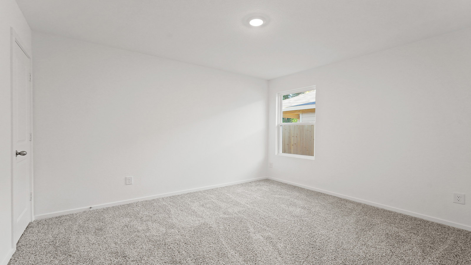 Primary bedroom with carpet flooring