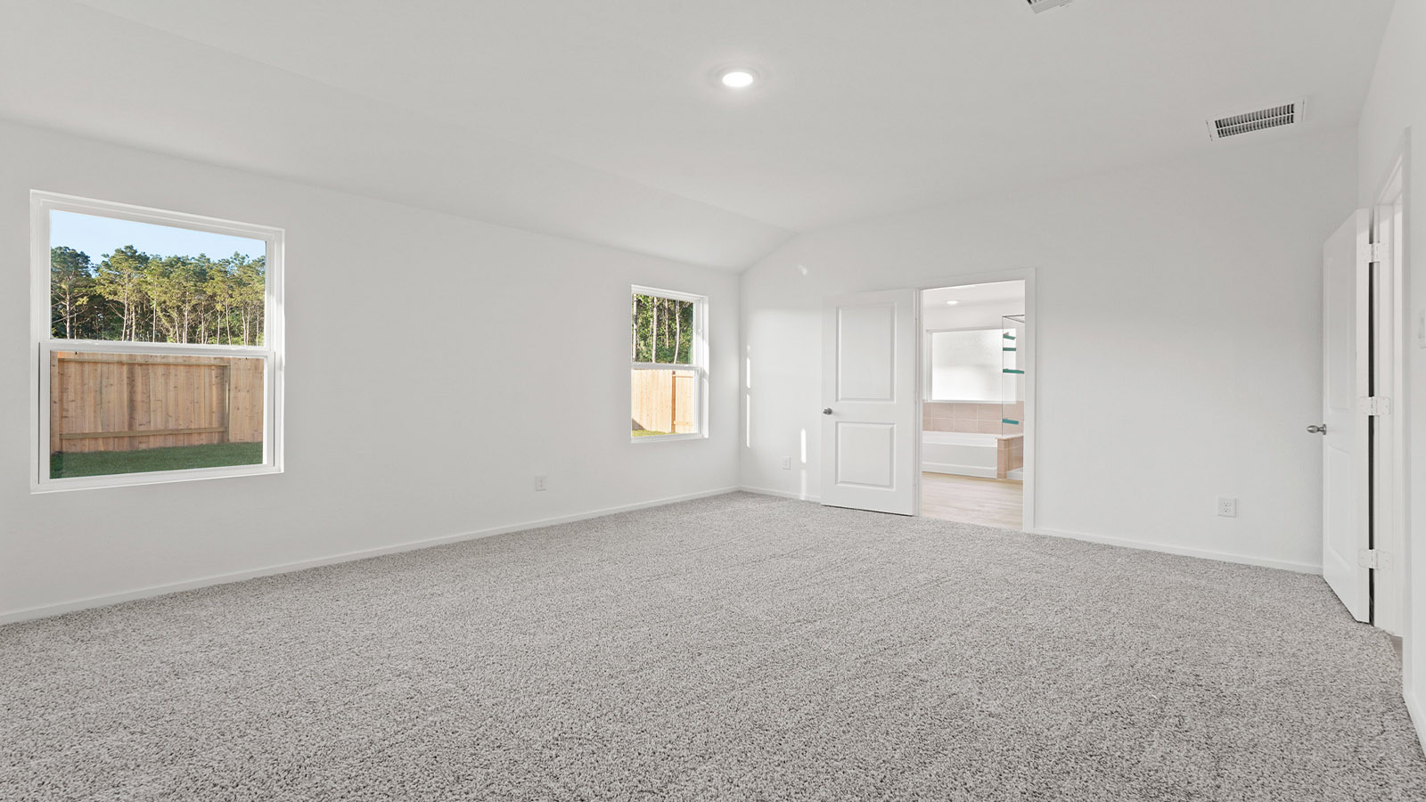 Primary bedroom with carpet flooring