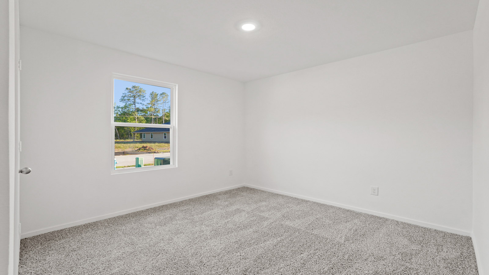 Secondary bedroom with carpet flooring