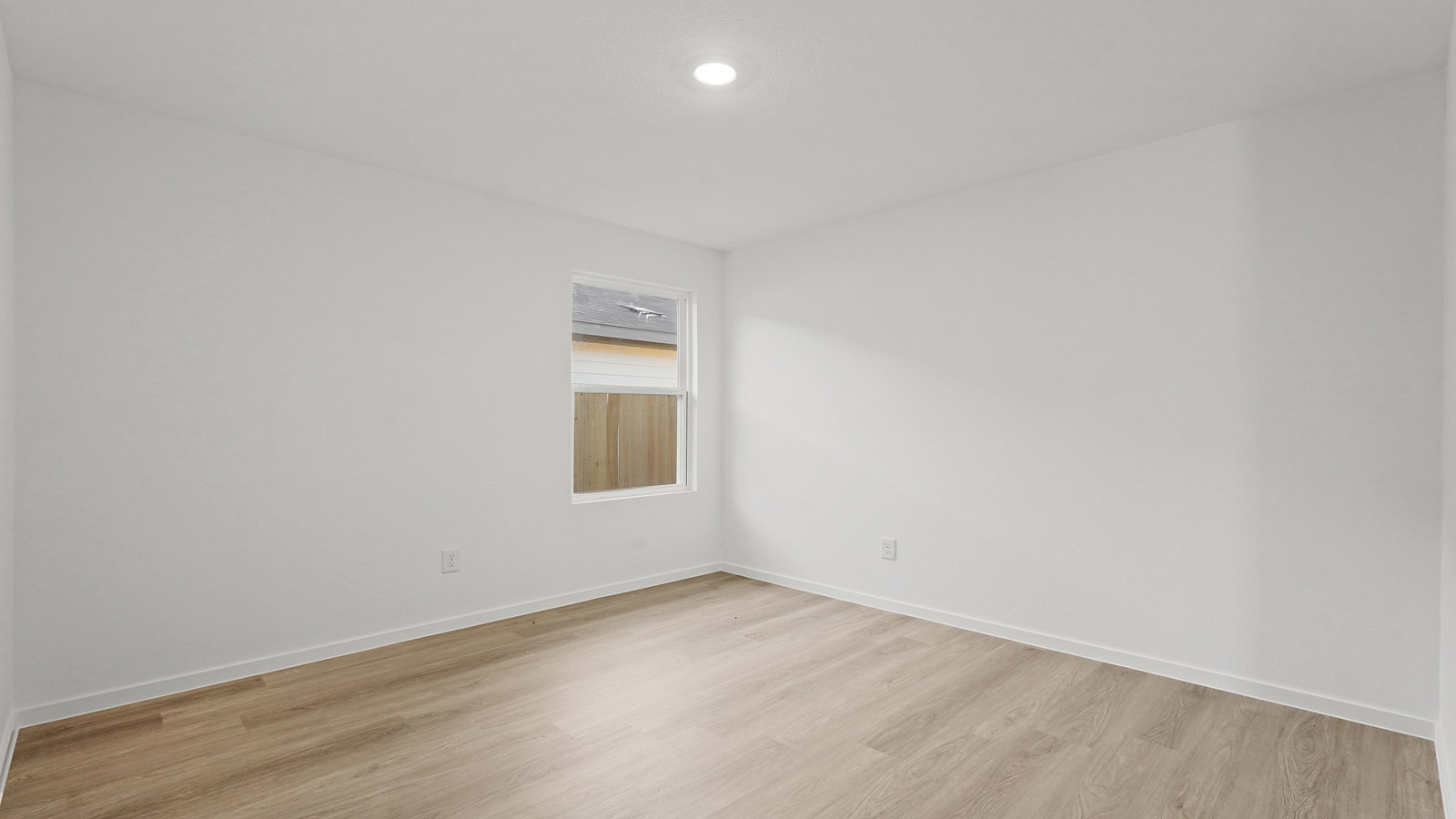 Spacious living area with vinyl flooring